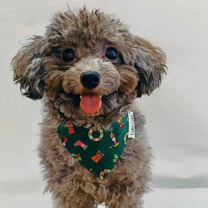 Grey dog wearing a green Christmas bandana, handmade holiday accessory for dogs and cats.